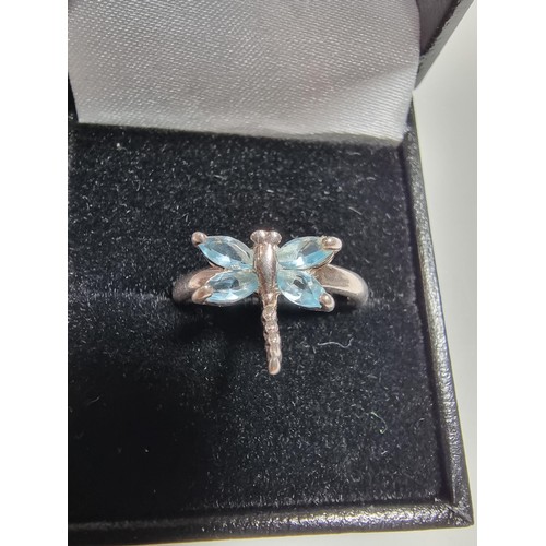 385 - A new old stock 925 silver dragonfly ring inset with blue stones.
size P, in a new quality ring box.