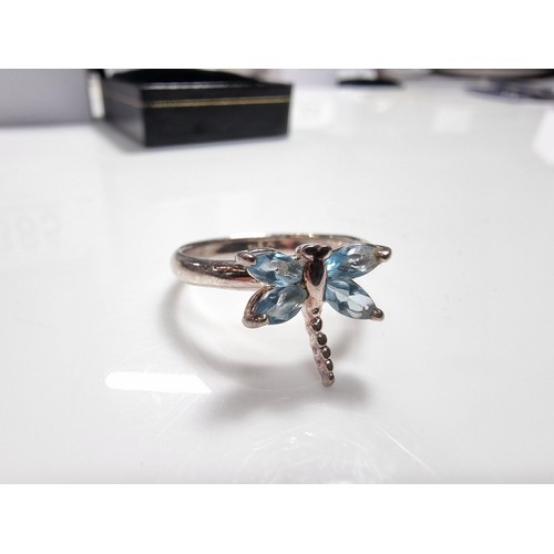 385 - A new old stock 925 silver dragonfly ring inset with blue stones.
size P, in a new quality ring box.