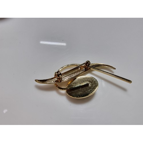 391 - A cased unused brooch by Ariki inset with nephrite jade made in New Zealand 22ct gold plated.