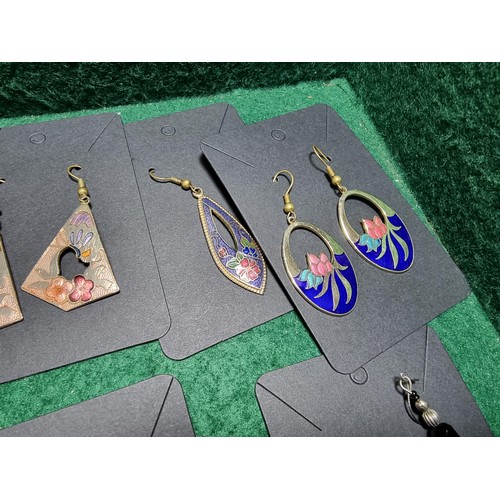 393 - A suite of various costume jewellery including enamelled earrings and ornate fob watch, matching jew... 