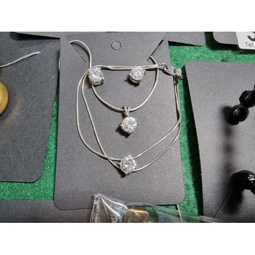 393 - A suite of various costume jewellery including enamelled earrings and ornate fob watch, matching jew... 