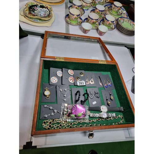 394 - A vintage wooden tabletop display case with a  glazed top in excellent condition, jewellery inside i... 