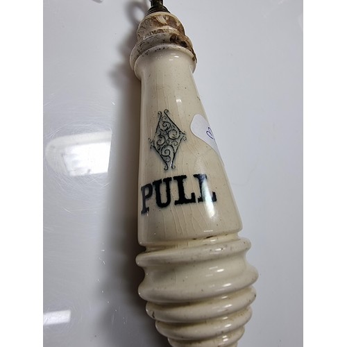 395 - An antique ceramic and brass lavatory chain handle.
in good overall condition with minor chips to th... 