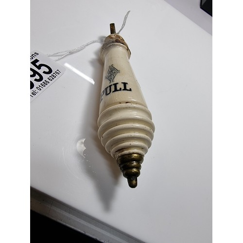 395 - An antique ceramic and brass lavatory chain handle.
in good overall condition with minor chips to th... 