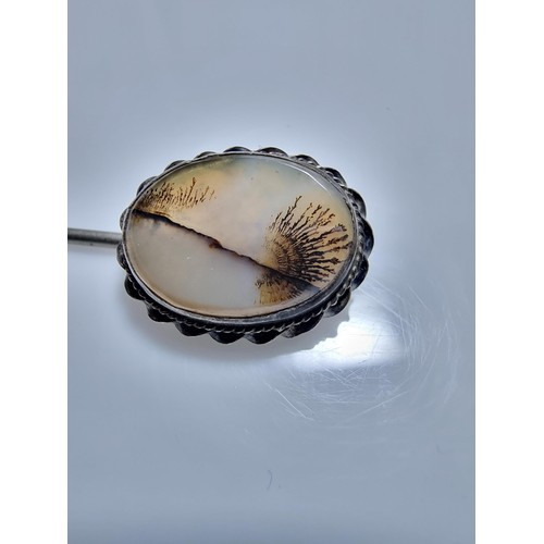 397 - A tested as silver antique stick pin inset with a dendrite crystal that has a natural multi branchin... 