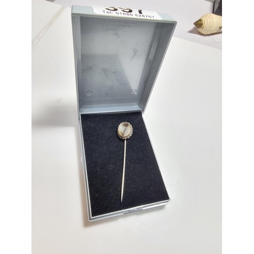 397 - A tested as silver antique stick pin inset with a dendrite crystal that has a natural multi branchin... 