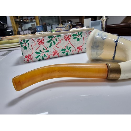 398 - A good quality vintage ceramic delft pipe with a goods butterscotch amber stem.
Stem and pipe in goo... 