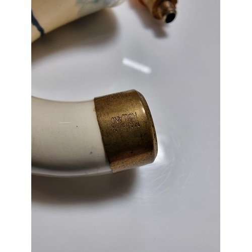 398 - A good quality vintage ceramic delft pipe with a goods butterscotch amber stem.
Stem and pipe in goo... 