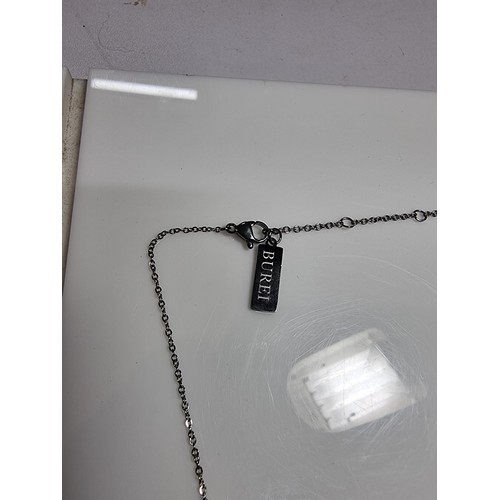 399 - A boxed as new leather wallet and necklace with a maya pendant by Burei.