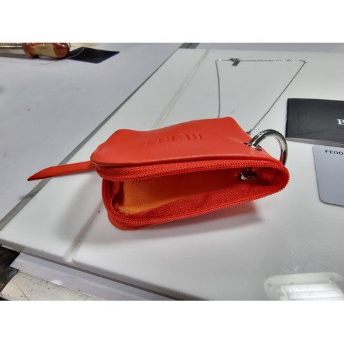 399 - A boxed as new leather wallet and necklace with a maya pendant by Burei.