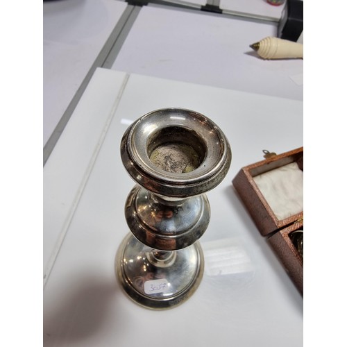 400 - A hallmarked silver candlestick along with a boxed hallmarked silver pair of serviette rings. Candle... 
