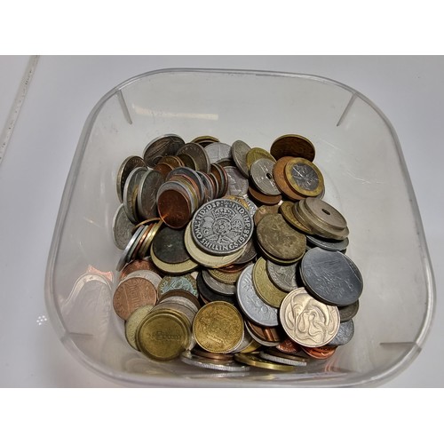 401 - A tub full of various world coins.