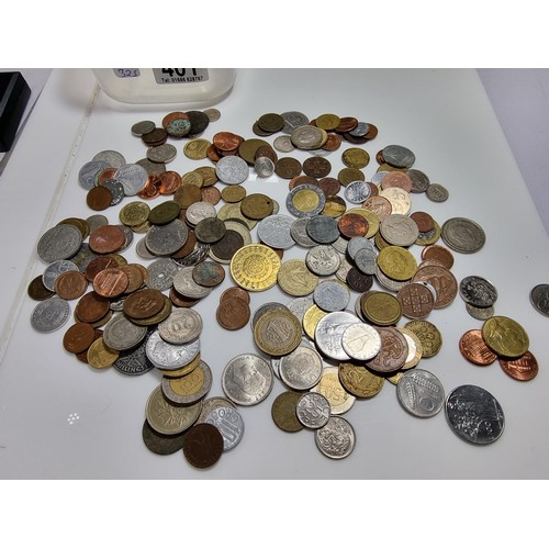 401 - A tub full of various world coins.