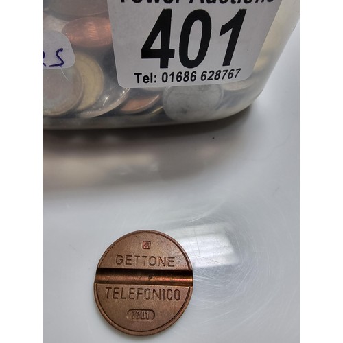 401 - A tub full of various world coins.
