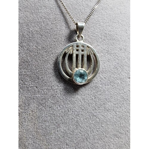 403 - A 925 silver pendant with a Rennie Macintosh design inset with a blue topaz stone set on an 18