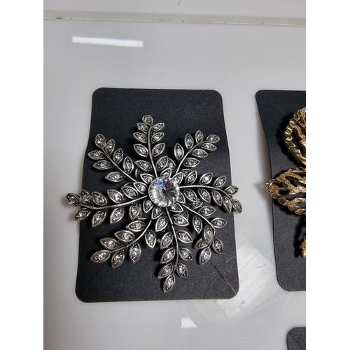 427 - A quantity of 6 ornate costume brooches including a signed designer leaf formed costume brooch by Sa... 