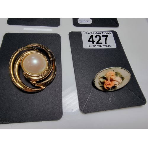 427 - A quantity of 6 ornate costume brooches including a signed designer leaf formed costume brooch by Sa... 