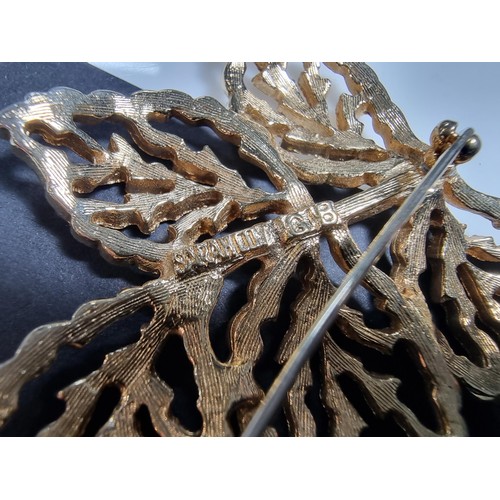 427 - A quantity of 6 ornate costume brooches including a signed designer leaf formed costume brooch by Sa... 