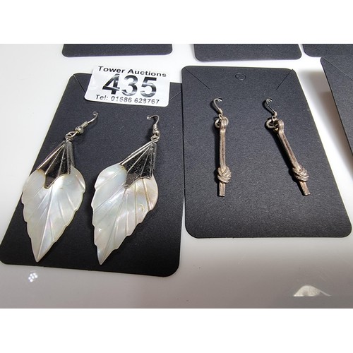 435 - A set of 12 pairs of costume earrings including some ornate pairs with m.o.p. gemstones etc.