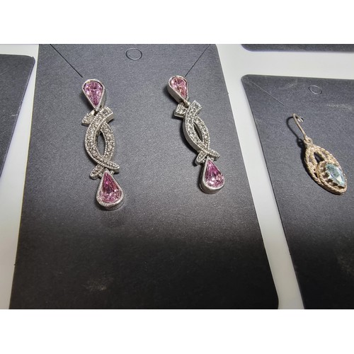 435 - A set of 12 pairs of costume earrings including some ornate pairs with m.o.p. gemstones etc.