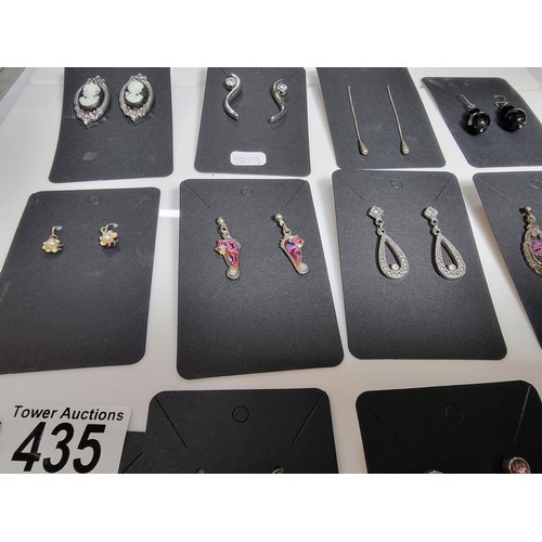435 - A set of 12 pairs of costume earrings including some ornate pairs with m.o.p. gemstones etc.