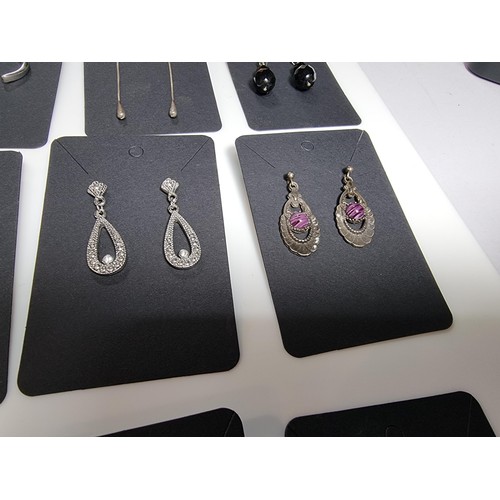 435 - A set of 12 pairs of costume earrings including some ornate pairs with m.o.p. gemstones etc.