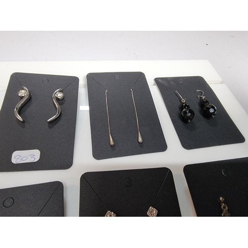435 - A set of 12 pairs of costume earrings including some ornate pairs with m.o.p. gemstones etc.