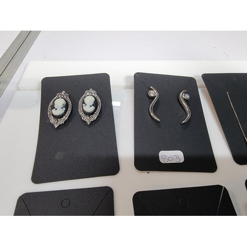 435 - A set of 12 pairs of costume earrings including some ornate pairs with m.o.p. gemstones etc.