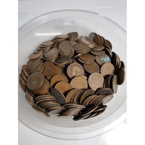 440A - A plastic tub full of mostly British copper half pennies.