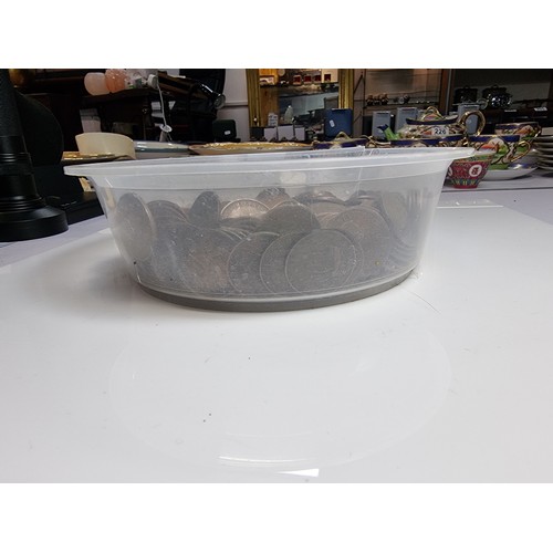 440A - A plastic tub full of mostly British copper half pennies.