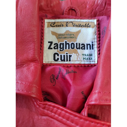 326A - A vintage red leather ladies jacket and mini skirt made by Zaghouani Cuir. In excellent condition, s... 