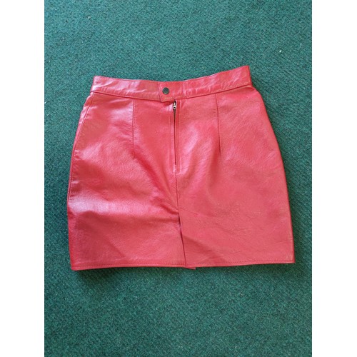 326A - A vintage red leather ladies jacket and mini skirt made by Zaghouani Cuir. In excellent condition, s... 