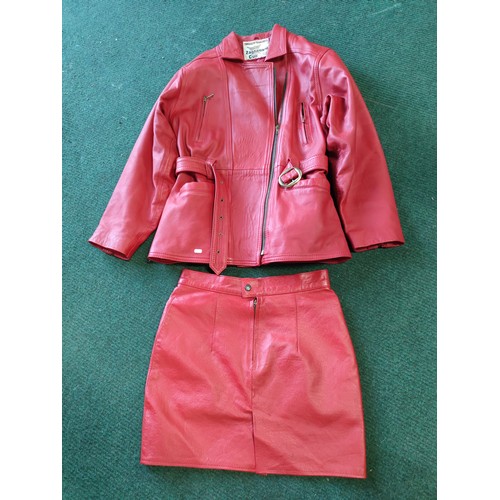 326A - A vintage red leather ladies jacket and mini skirt made by Zaghouani Cuir. In excellent condition, s... 