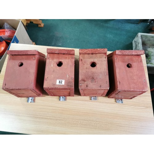 82 - Quantity of 4x wooden bird boxes complete with wall hangers in good order, height 30cm length 15cm d... 