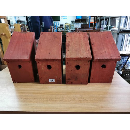 82 - Quantity of 4x wooden bird boxes complete with wall hangers in good order, height 30cm length 15cm d... 