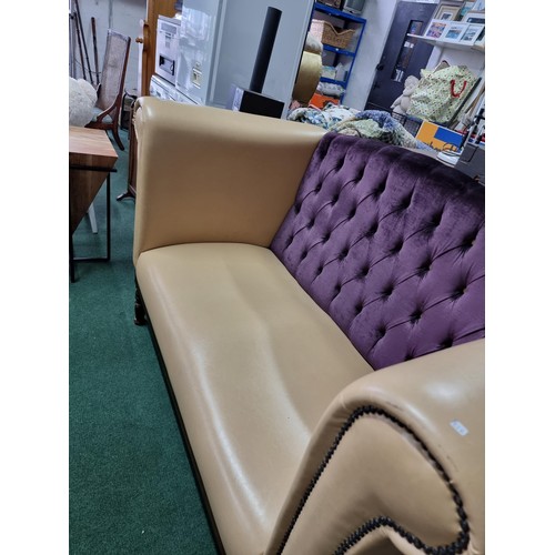 459 - Unusual cream leather deep arm sofa with studded fronts and a purple upholster button back in good c... 