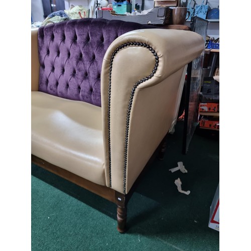 459 - Unusual cream leather deep arm sofa with studded fronts and a purple upholster button back in good c... 