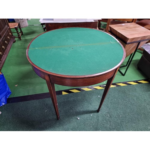 470 - Antique mahogany half moon table which folds out to be a circualr games table with a green baize wit... 