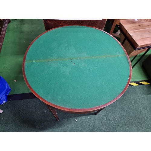 470 - Antique mahogany half moon table which folds out to be a circualr games table with a green baize wit... 