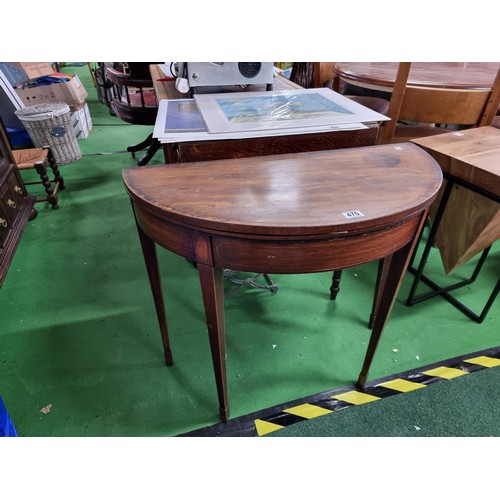 470 - Antique mahogany half moon table which folds out to be a circualr games table with a green baize wit... 