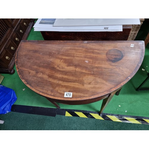 470 - Antique mahogany half moon table which folds out to be a circualr games table with a green baize wit... 