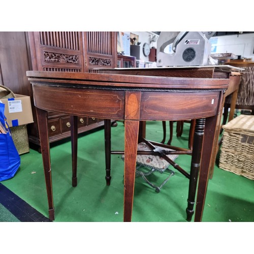 470 - Antique mahogany half moon table which folds out to be a circualr games table with a green baize wit... 