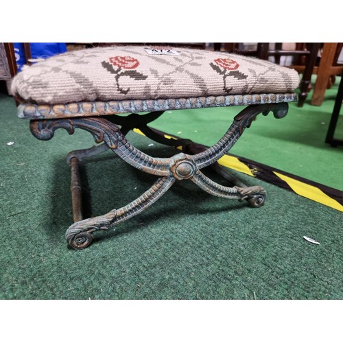 472 - Ornate antique footstool with a metal frame and an upholstererd top in good condition height 22cm le... 