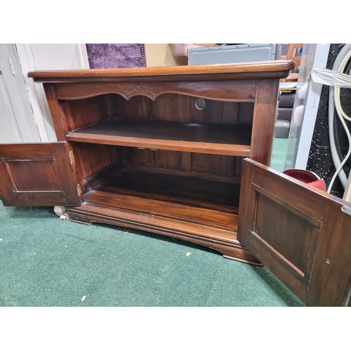 478 - Fine quality solid Brazilian rosewood TV cabinet of solid construction with two panelled drawers to ... 