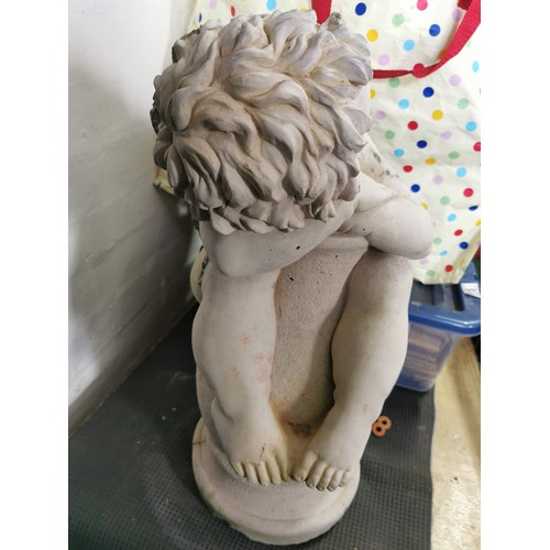 76 - Stunning vintage stoneware cherub seated on a baluster garden figure presenting excellent detail. in... 