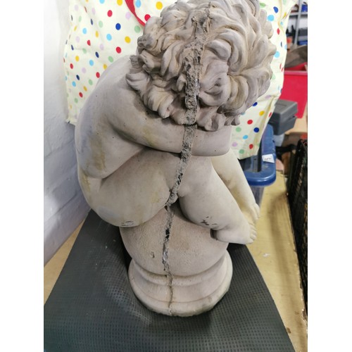 76 - Stunning vintage stoneware cherub seated on a baluster garden figure presenting excellent detail. in... 