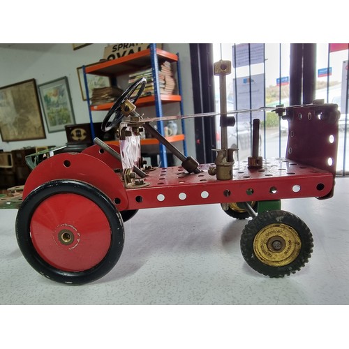 161 - An early vintage Meccano red tractor and trailer fully assembled all with original parts in good vin... 