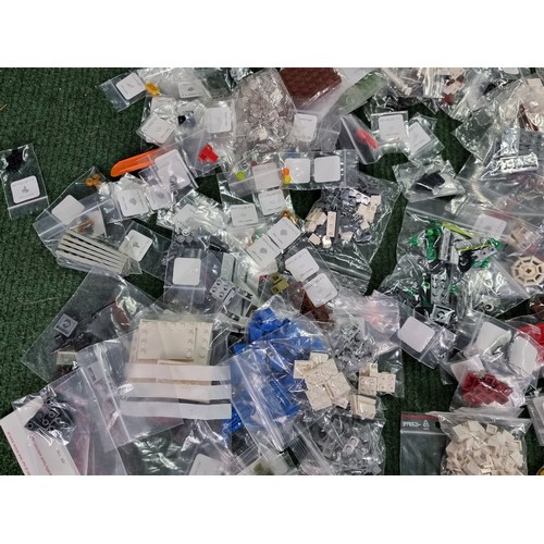 165 - A large collection of specialist Lego pieces 2.7kg in total. Including many new and sealed spare Leg... 