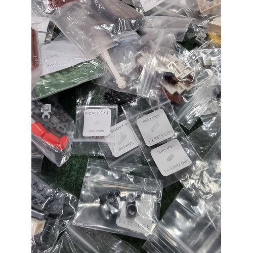 165 - A large collection of specialist Lego pieces 2.7kg in total. Including many new and sealed spare Leg... 