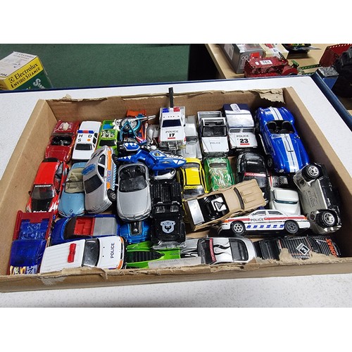 173 - A box containing a large quantity of vintage diecast cars including an early vintage police car whic... 